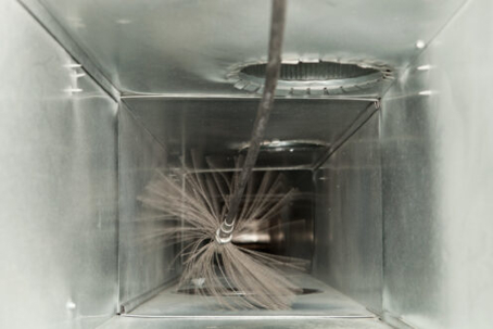 Cleaning a metal air duct with a brush