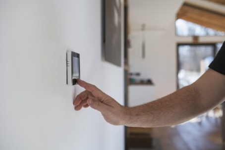 Adjusting a wall-mounted thermostat