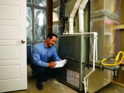 Technician inspecting a home furnace