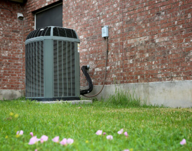 AC unit outside on a brick wall