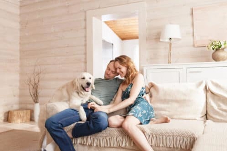 Couple with their dog on a couch